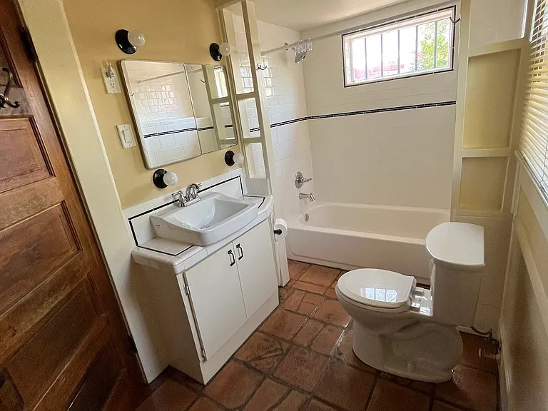 Bathroom with tub and shower, extra storage and linen closet.