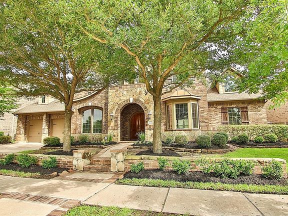 Energy Star Certified home with brick and stone elevation, brick lined walkway and arched covered front entry. Great curb appeal!