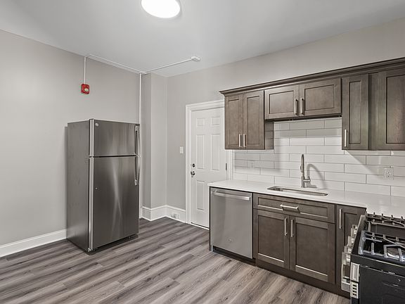 Kitchen with gas stove and dishwasher. All new appliances, quartz counters and new cabinets.