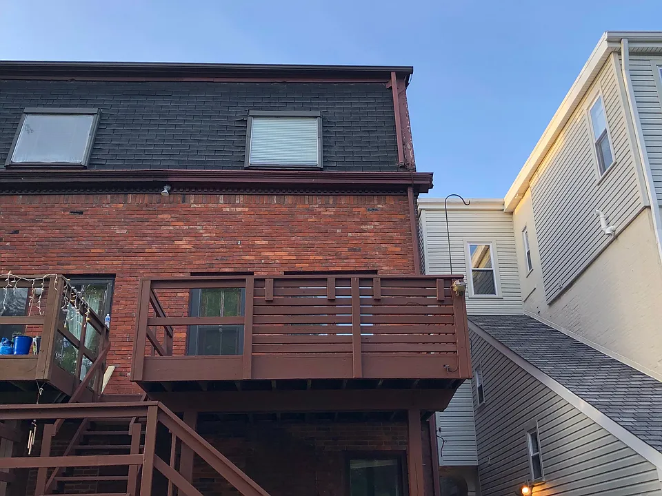 Back deck and entrance from private off- street parking area.