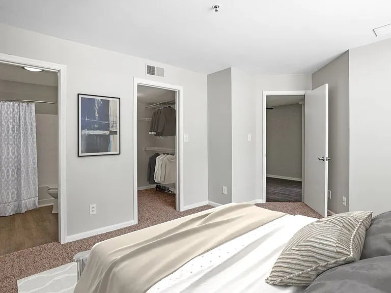 Primary bedroom with convenient private bathroom access and a large closet at The Crossings at Russett in Laurel, MD