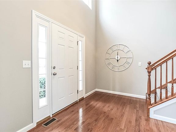 Two story foyer at entry and stairs to upper level
