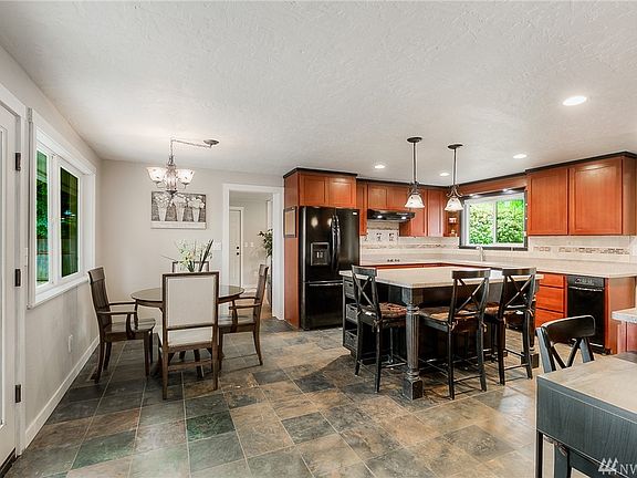 Large open kitchen with breakfast bar and dining space. 