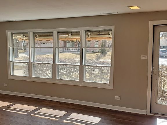 Living room - front windows and door from hallway.