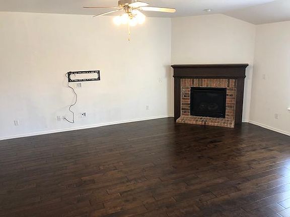 Living Room open to kitchen and dining room. Dimensions: 18' x 23'