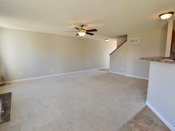 Looking back toward the front door, there is a powder room for guests and stairs leading to an open loft space!