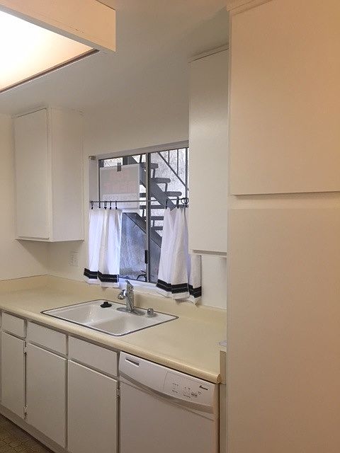 Kitchen freshly painted and has good lighting.