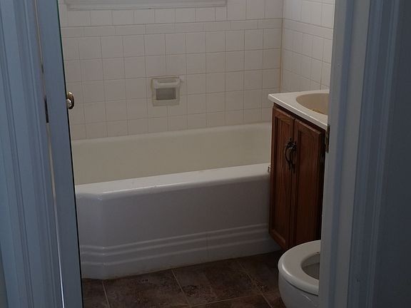 Bathroom - newly laid tile floor and new tile in shower