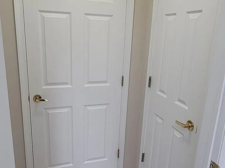 Primary bedroom entrance to closets and bathroom