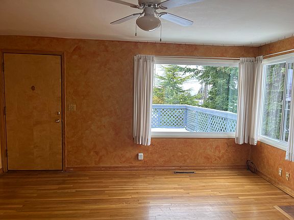 Living room facing west balcony out bay window.