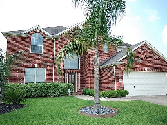 Large family room with art niches, pretty fireplace and great windows!