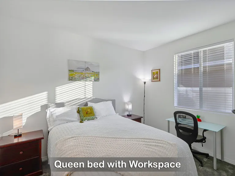 Queen bed with a dedicated workspace, ideal for both relaxation and productivity.