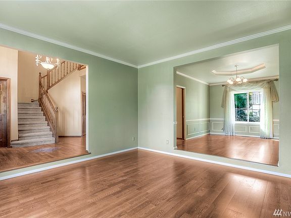 The formal living and dining rooms have crown molding and laminate flooring.