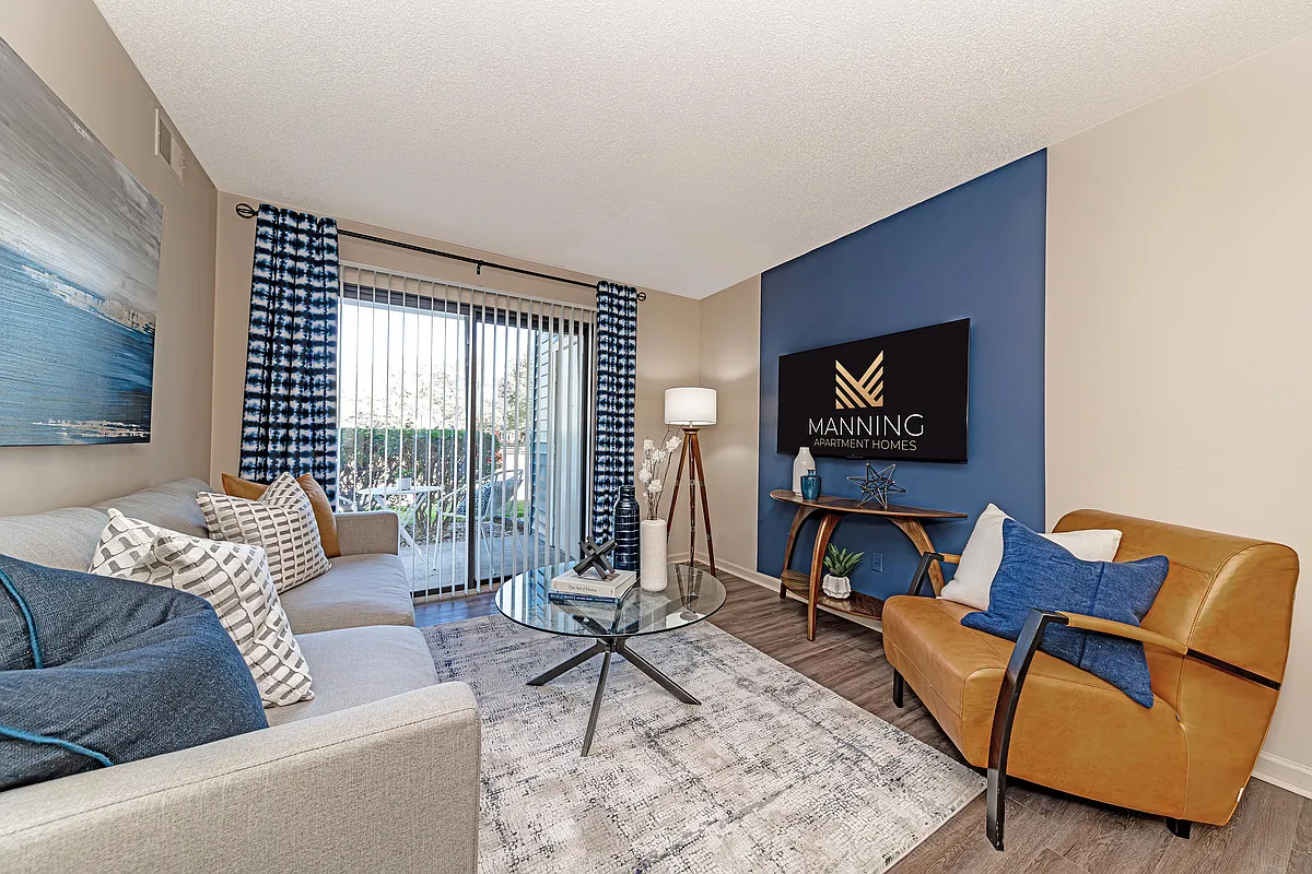Spacious living room with hardwood-style flooring - The Manning