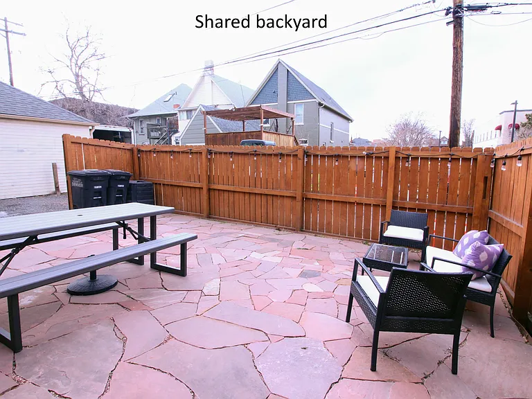 Backyard patio with space for furniture, grill, and plants