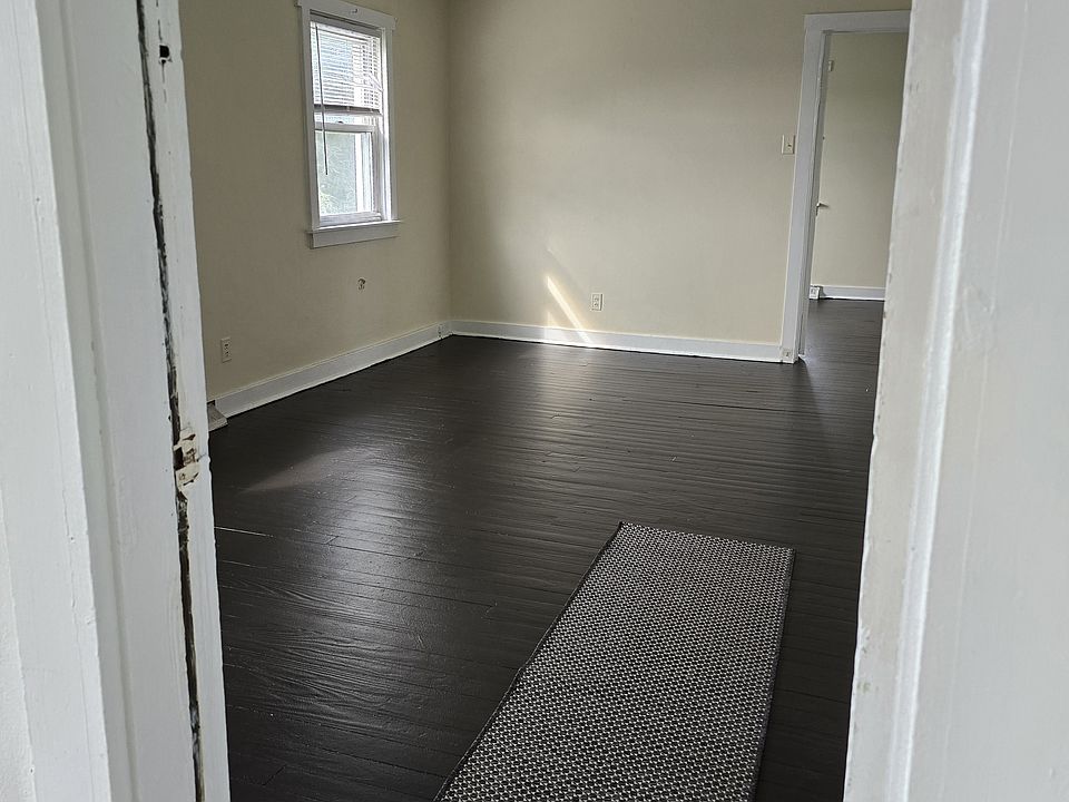Front door on porch opening into the living room.