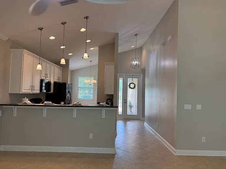 View from Great Room to front of home. Room for 4 barstools on left.