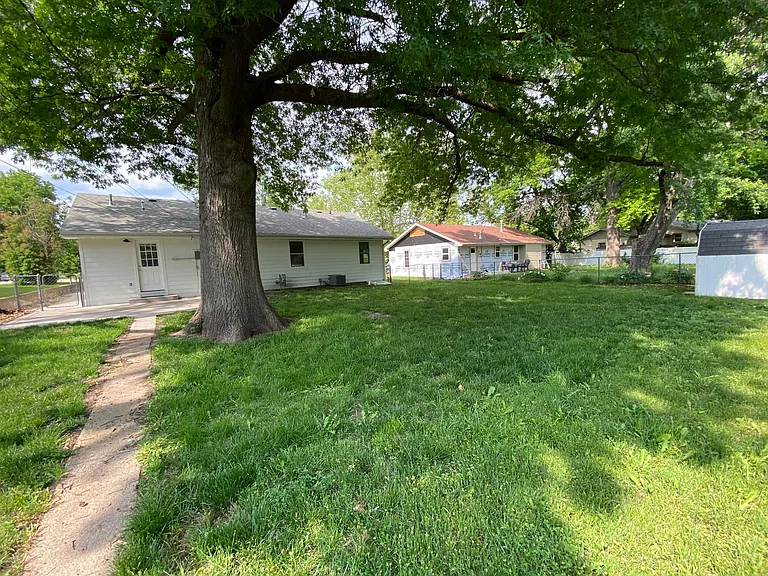 Backyard from back fence line looking at back of house.