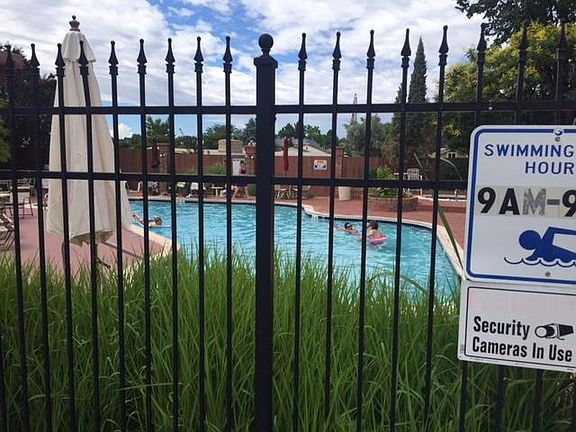 Pool area with grills and access to gym