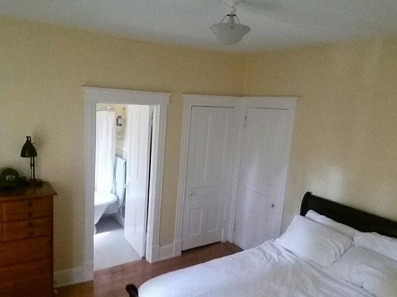 Bedroom and view of bathroom claw foot tub