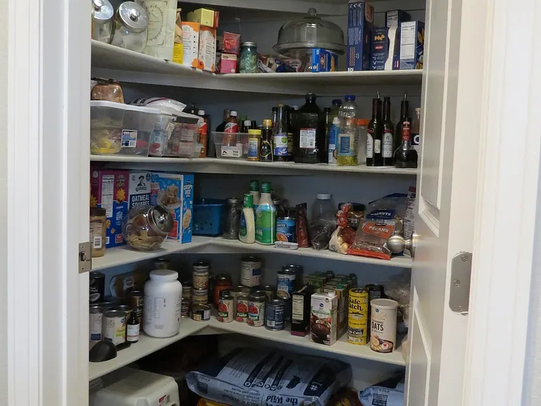 Large walk-in pantry with wrap around shelving