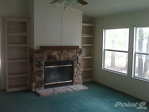 Family room has built-in bookcases and fireplace