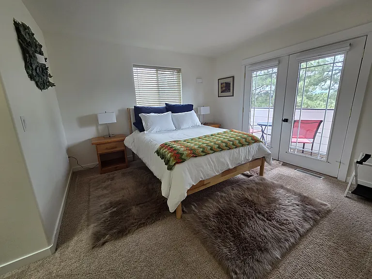 Master bedroom view of private balcony with seating.