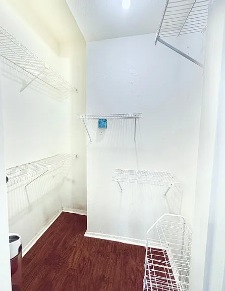 A walk-in closet inside the 1st bedroom