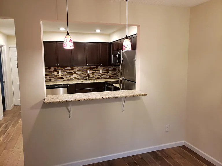 breakfast bar between kitchen and dining area