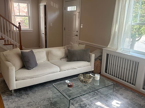 Living room with view of front entrance and window