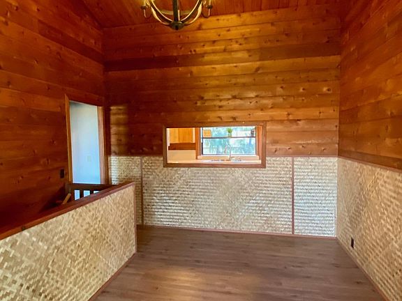 Entry doors open to large foyer. Lots of possibilities with this room. The pass through alcove opens to the kitchen. The stairway to the left leads downstairs to the laundry room and separate Ohana rental.