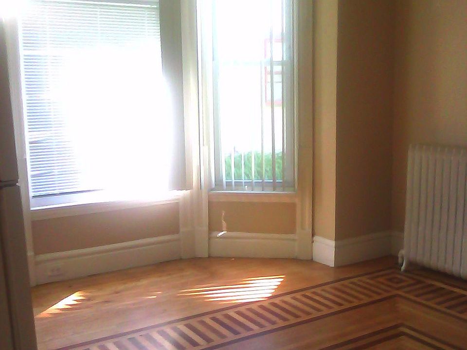 Bedroom prior to current Tenant. Huge bay window. Beautiful inlaid flooring.