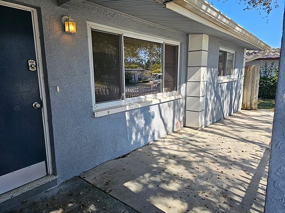 Large front porch is waiting for potted plants and a porch swing! Gate to backyard.