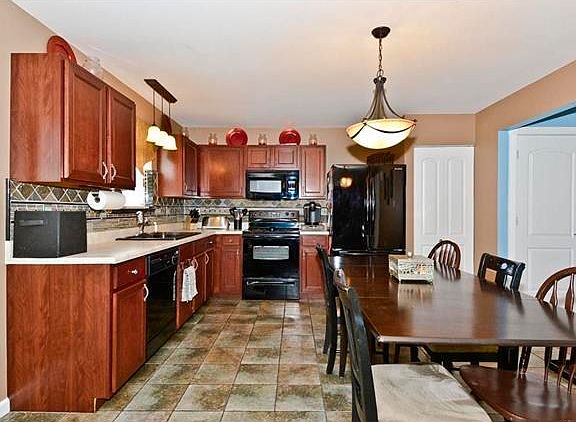 Great Kitchen space with newer lighting fixtures and matching backsplash