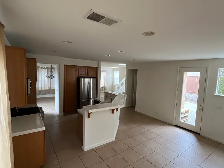 View of kitchen and side door to driveway from kitchen dining area