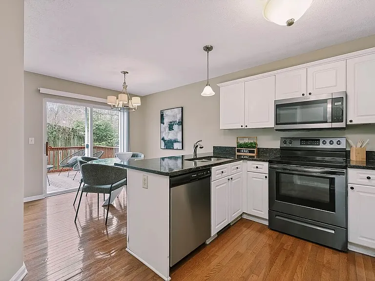 Kitchen and dining area. All appliances are included. Furniture is for illustrative purposes only.