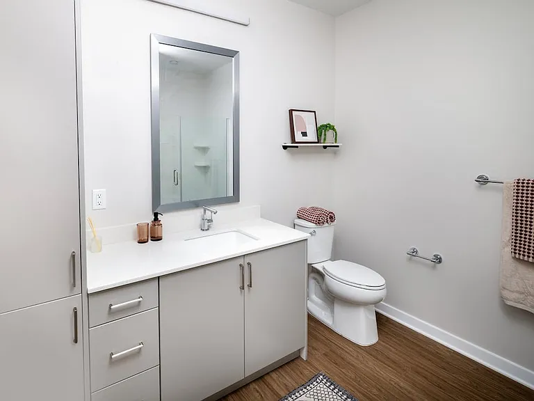 Upgrade Collection bath with light grey cabinetry, white quartz countertop, and hard surface flooring