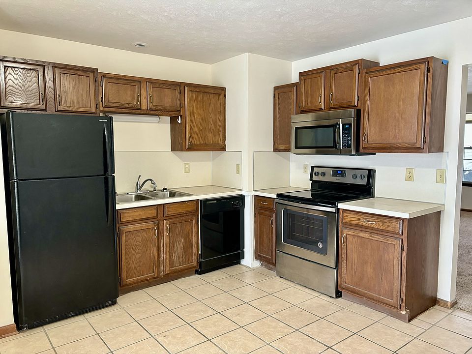 Kitchen with new dishwasher and microwave.