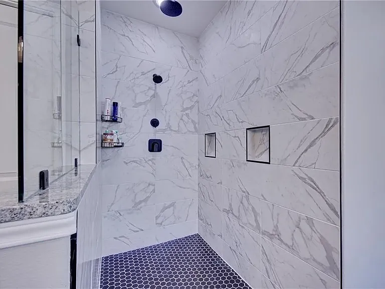 Primary shower featuring dual shower heads for a comfortable, spa-like experience.