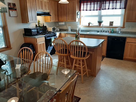 Gourmet kitchen with island, barstools included.