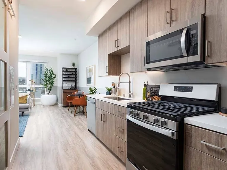 Studio and den layouts available at Modera San Diego featuring quartz countertops, gas ranges with sleek modern design