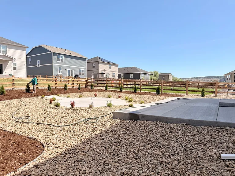 Large patio at back yard entrance (30ft x15ft) with another circular lounge area in the center of the yard (needs fire pit)