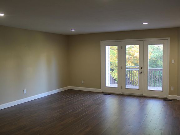 Living Room with Fireplace and large windows for extra light throughout the day.