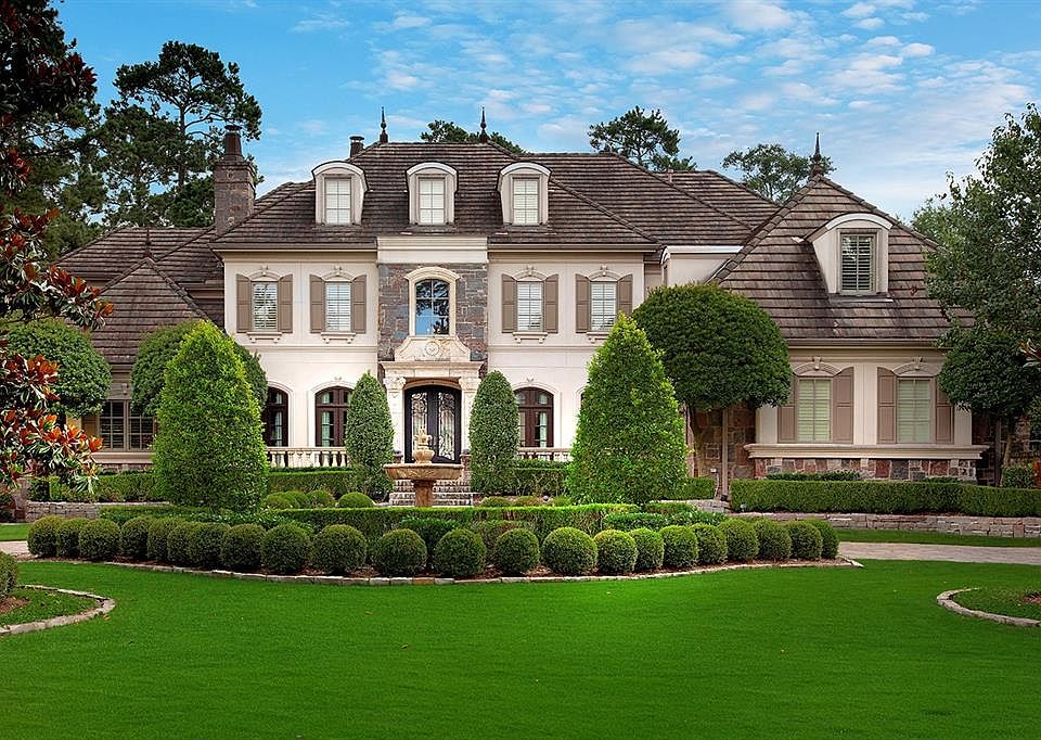 The paver circle driveway leads you thru the terraced gorgeous, extensive landscaping to the front entry. Take notice of the mature trees and carpet-like grass.