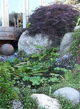 Custom water feature designed specifically for this site just outside the greatroom. Enjoy the sound