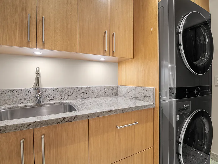Spacious laundry with Fisher & Paykel fridge drawers (not shown) located in the downstairs wing conveniently near secondary bedrooms.