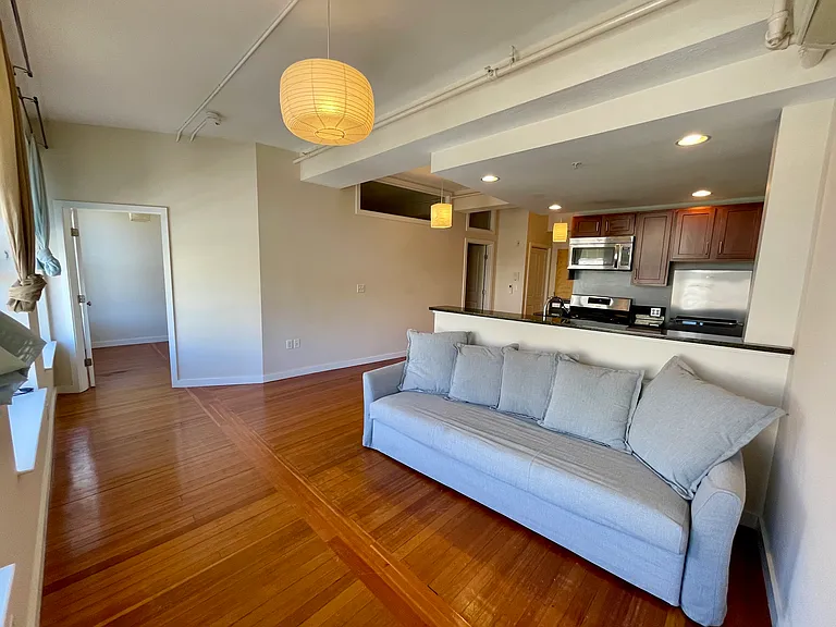 Looking towards the second bedroom, living room and kitchen.