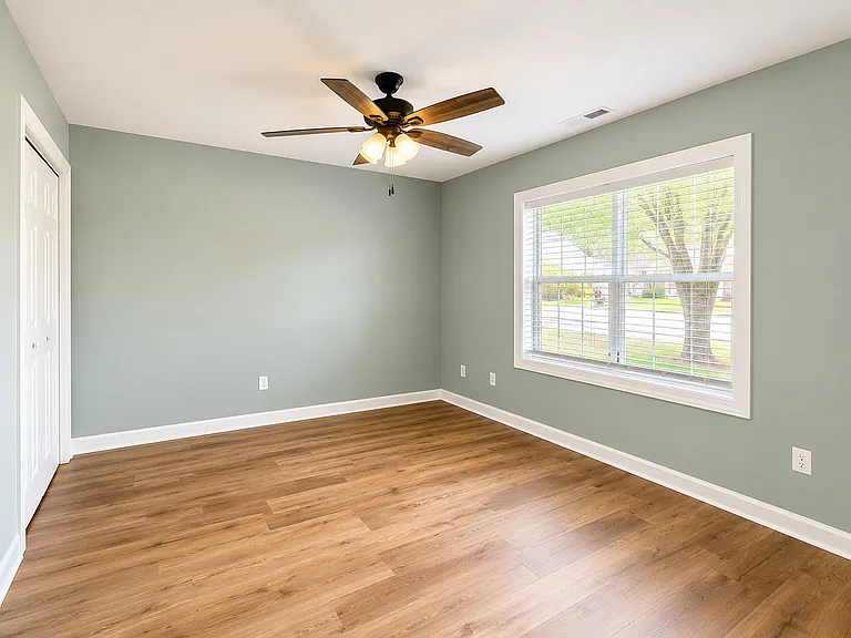 Downstairs bedroom with ceiling fan & closet. Connected to downstairs bathroom.