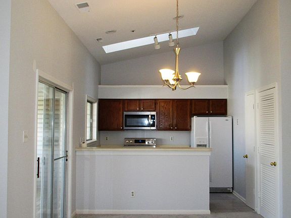 Separate dining area with new light fixture, leading to priv