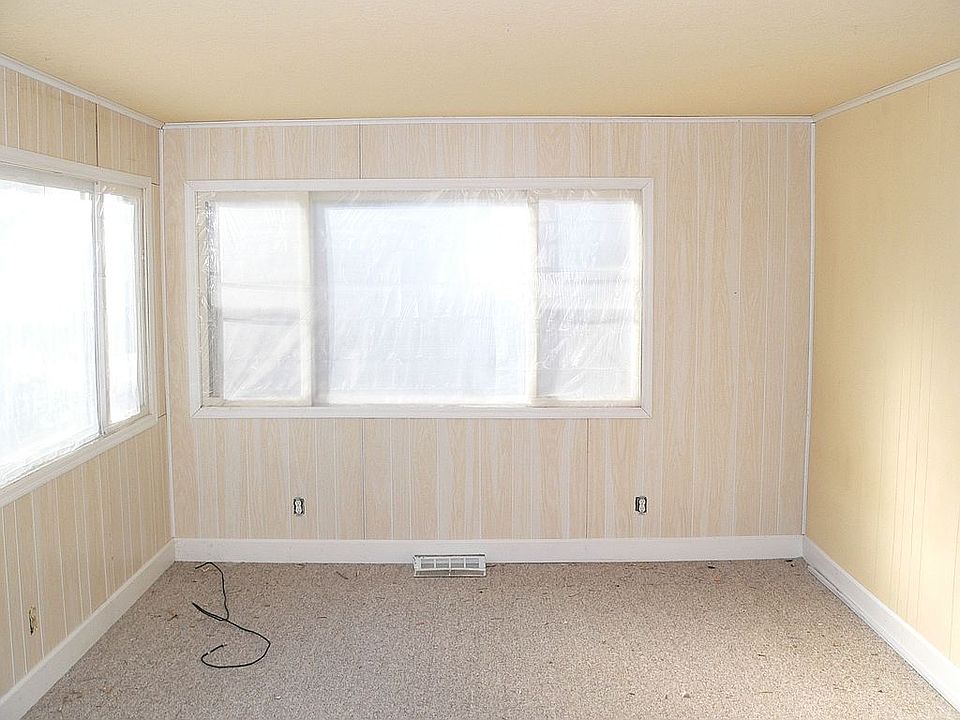 New wall paneling, carpet, and insulation in front room